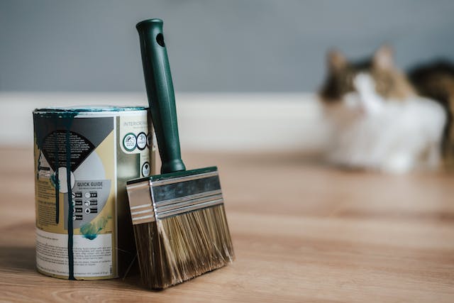 paint-brush-leaning-against-can-of-paint paint-brush-leaning-against-can-of-paint